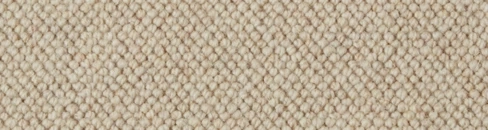 Close-up texture of cream wool loop pile carpet