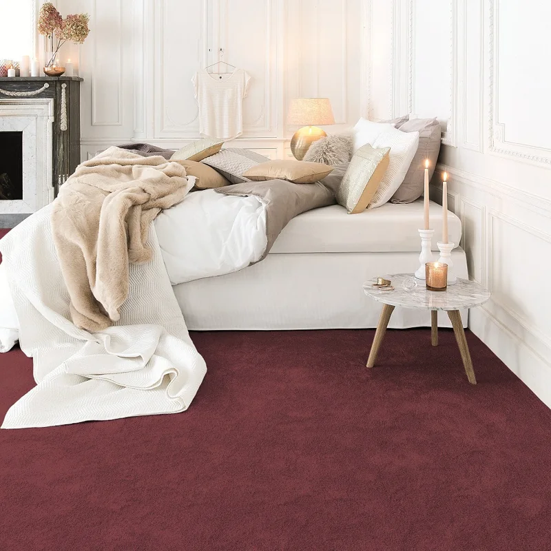 Luxurious burgundy wall-to-wall carpet in a modern white bedroom.