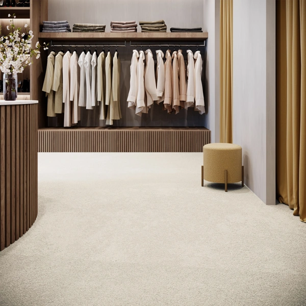 Luxury retail showroom featuring a cream wool carpet, ribbed wooden accents